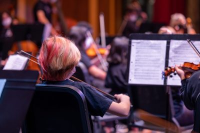 young musician with violin participating in string concert